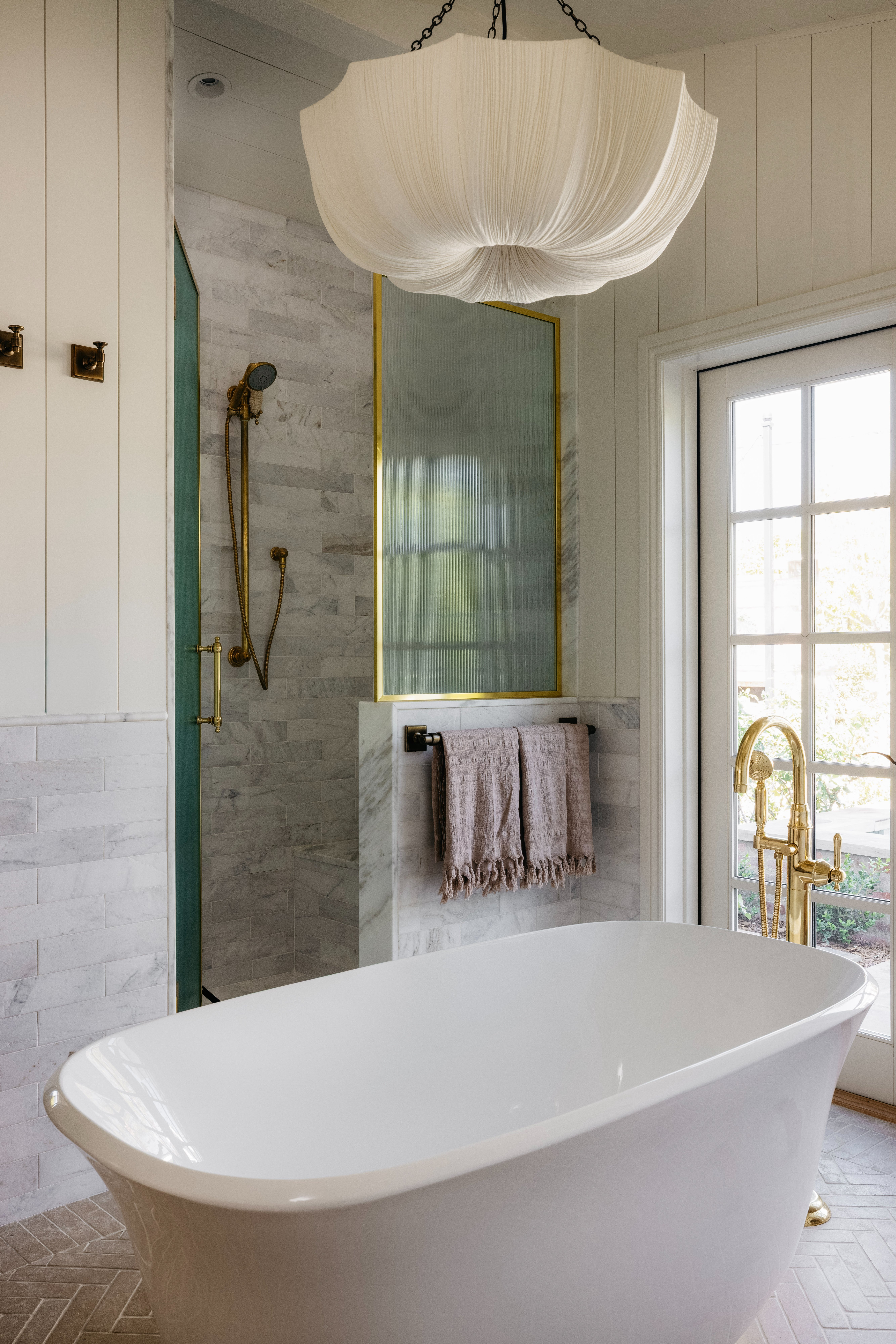 Primary bath tub with chandelier