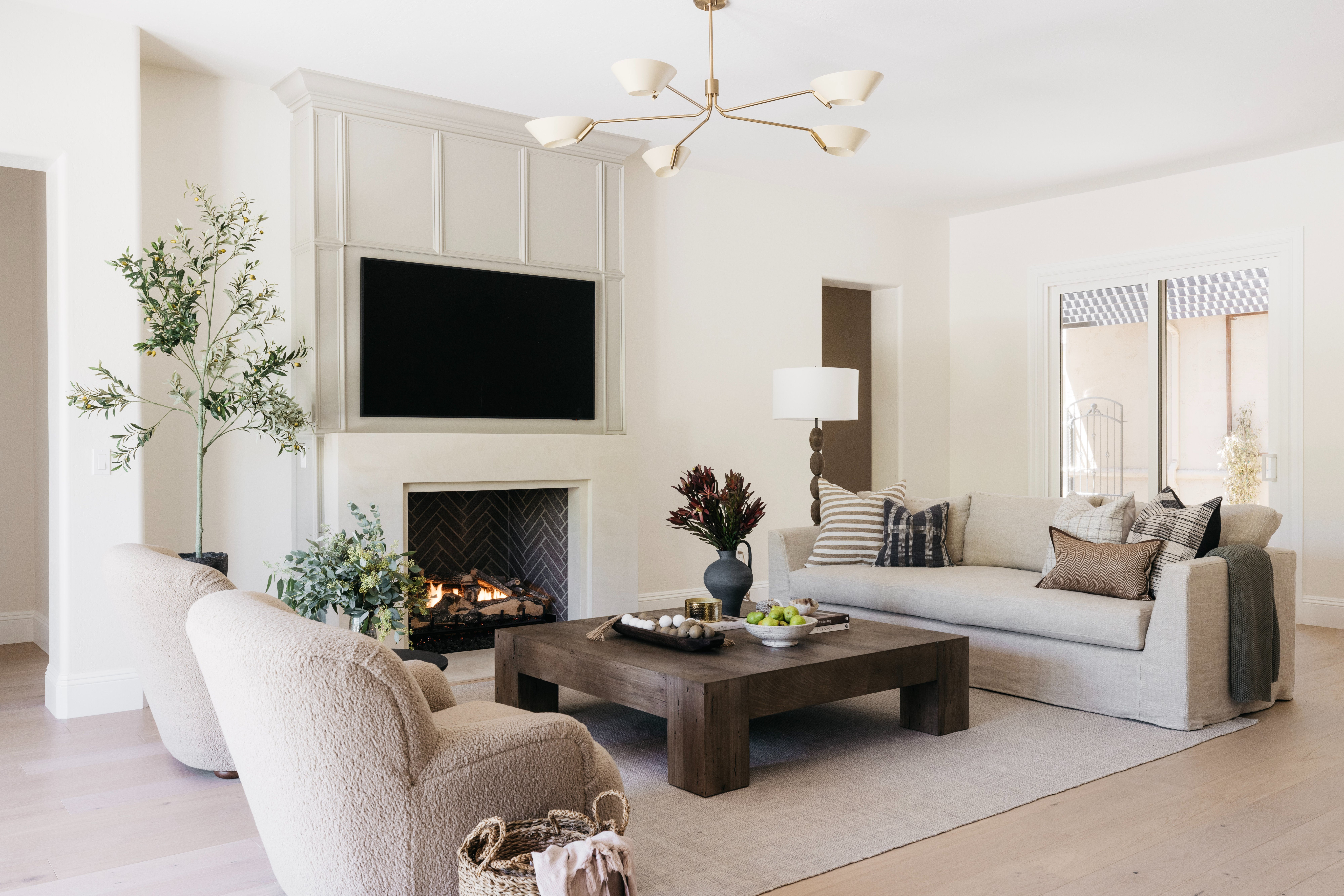 Fireplace detail with boucle chairs, The Open House